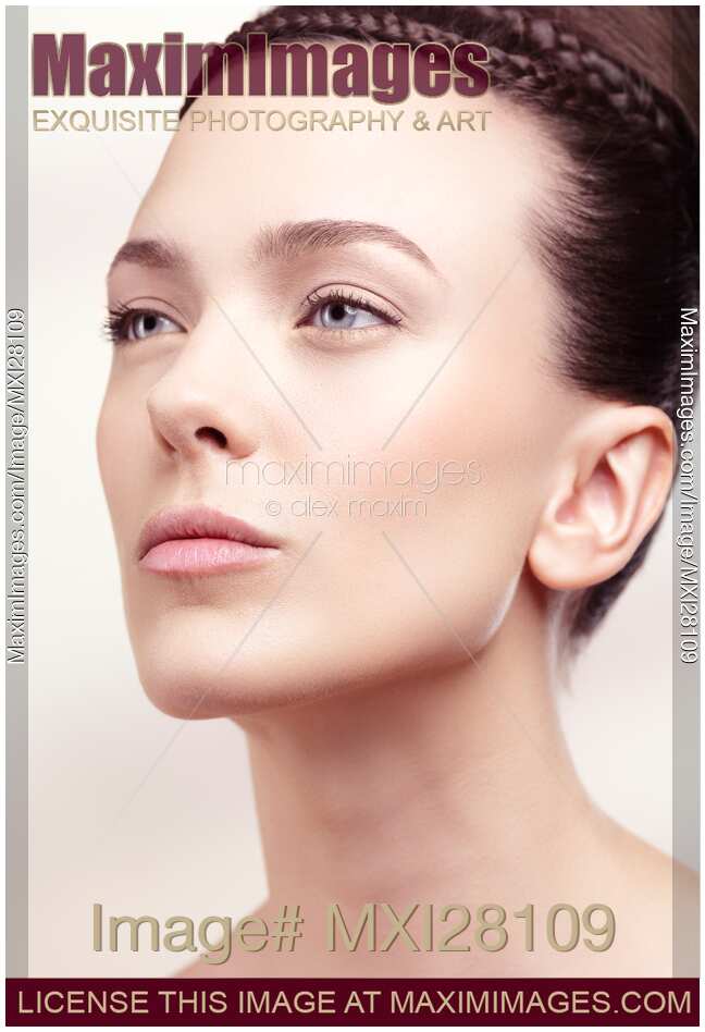 Beauty portrait of woman with clean natural look and updo hairstyle