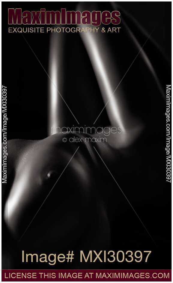 Black and white art nude portrait of a sexy woman body with in dim light artistic closeup of breast