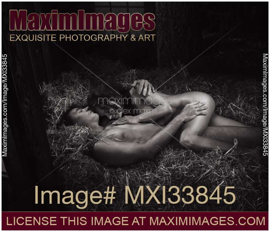 Black and white, beautiful nude sexy couple lying asleep naked cuddled in embrace on straw in barn