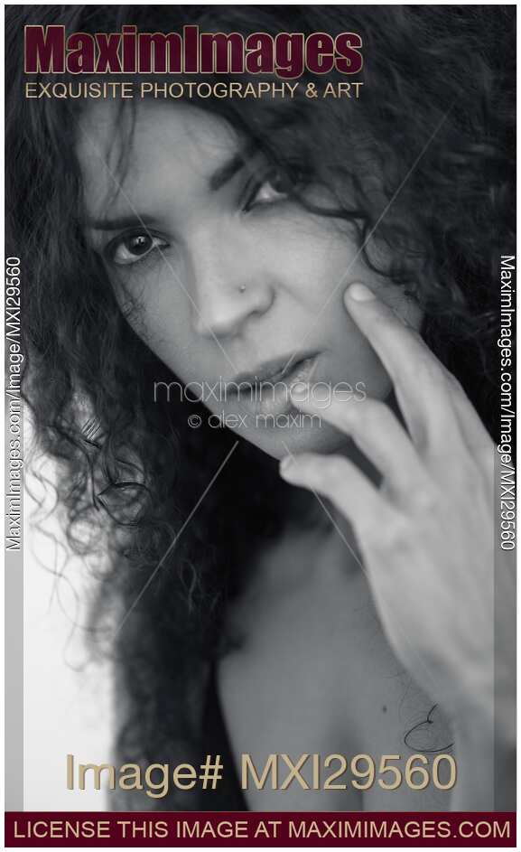 Black and white face portrait of a young brunette woman with a deep expressive look