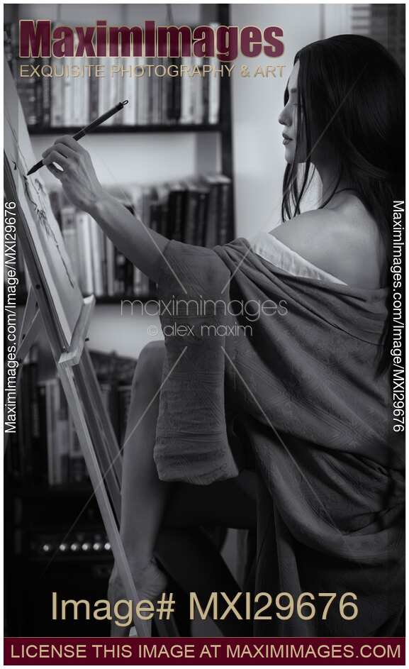 Black and white portrait of asian woman sumi-e artist in kimono with easel painting in her home studio