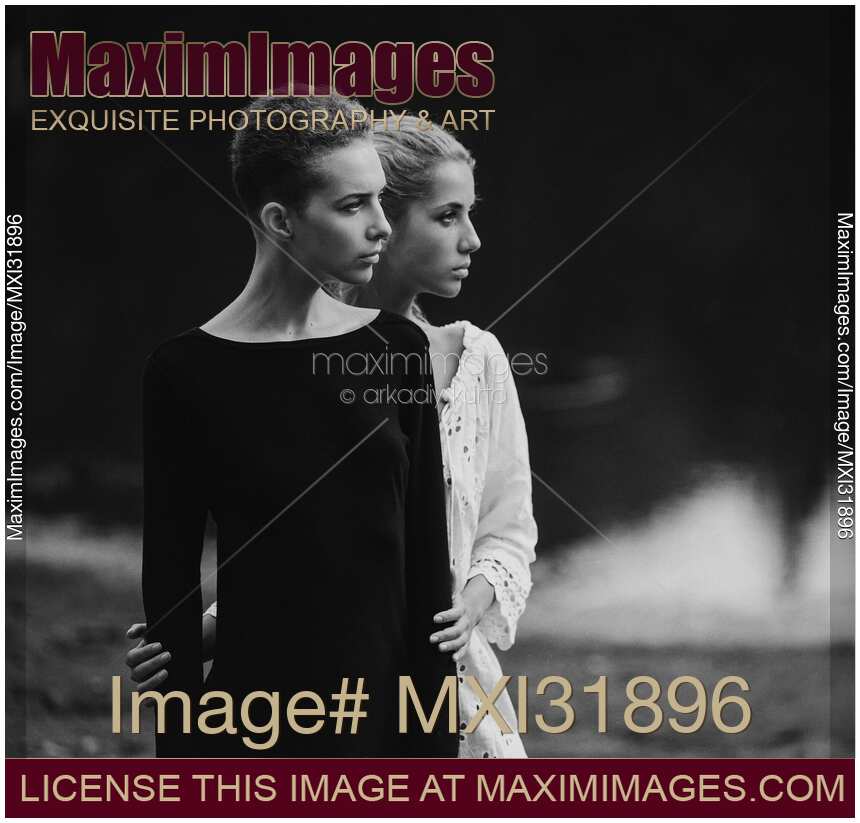 Black and white portrait of two young women standing together