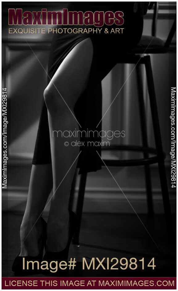 Black nd white closeup of sexy legs of woman wearing tight black skirt with high cut