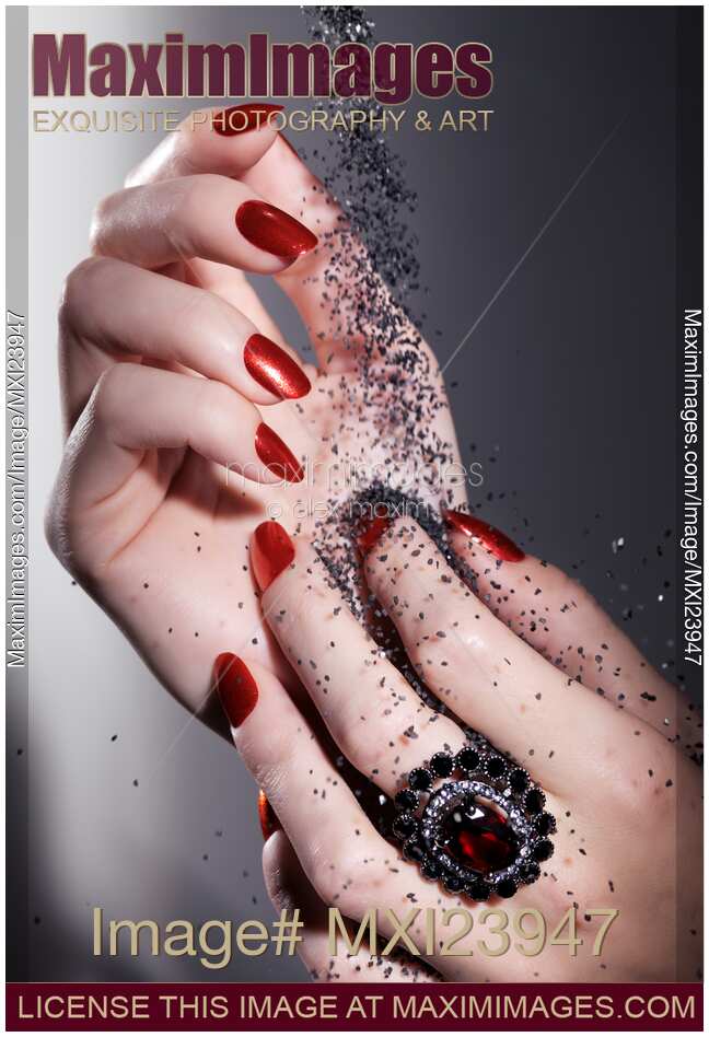 Black Sand Falling on Woman Hands
