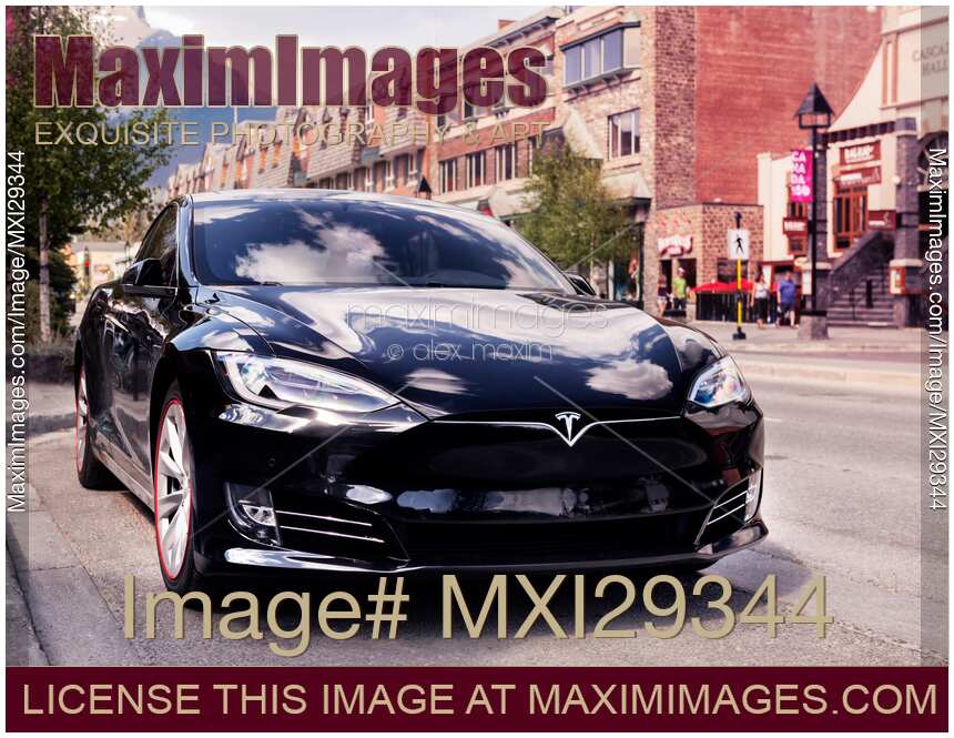 Black Tesla Model S luxury electric car parked on a city street