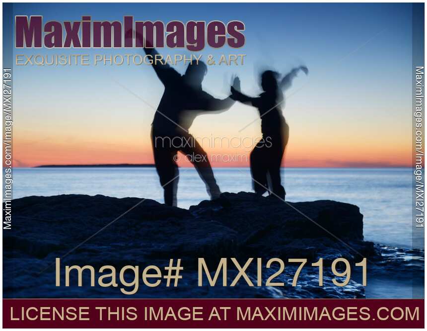 Blurred silhouettes of people practicing martial arts