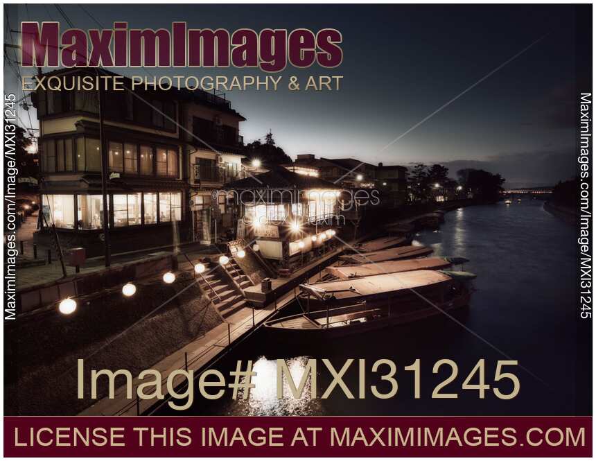 Boats at the bank of Uji River in a timeless night city scenery Japan