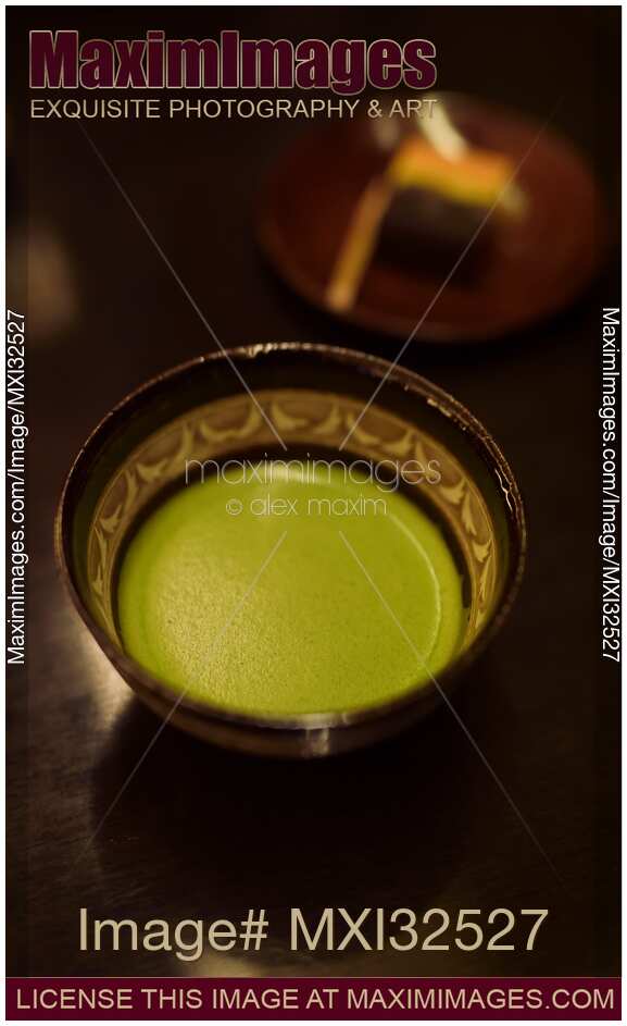 Bowl of Japanese Matcha ceremonial green tea and wagashi confection on a table