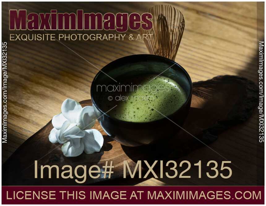 Bowl of Japanese Matcha green tea with a bamboo whisk Artistic still life