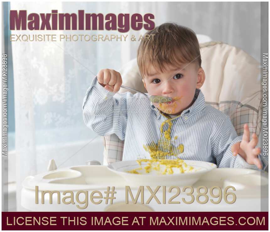 Boy Eating Soup with a Spoon