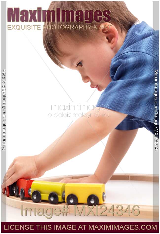 Boy plaing with a toy railroad