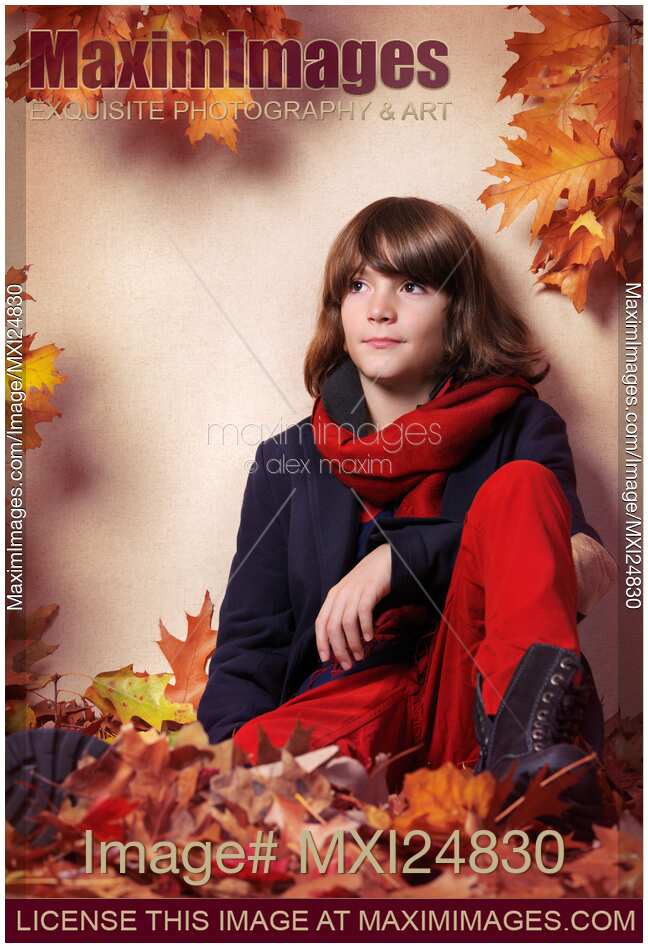Boy sitting on autumn leaves fall fashion style