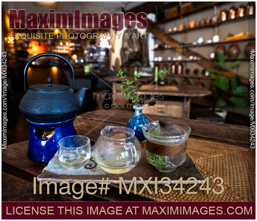 Brewing Oolong tea in a glass teapot on a wooden table of an old tea house