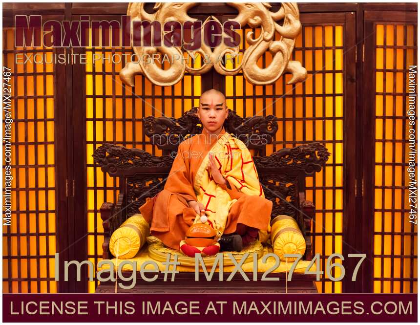 Buddhist monk meditating with wooden fish