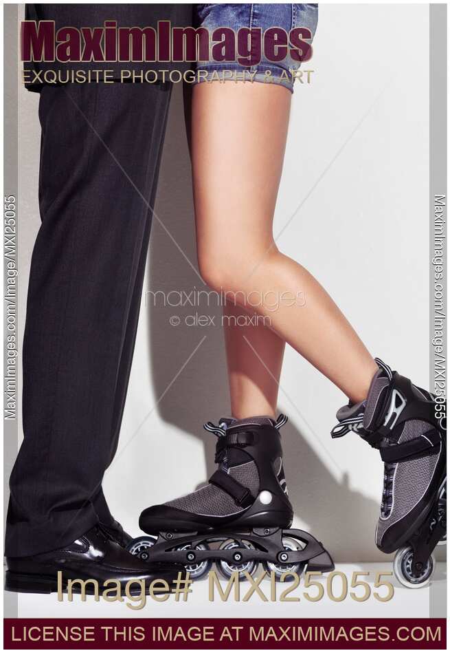 Business man and young woman in skates