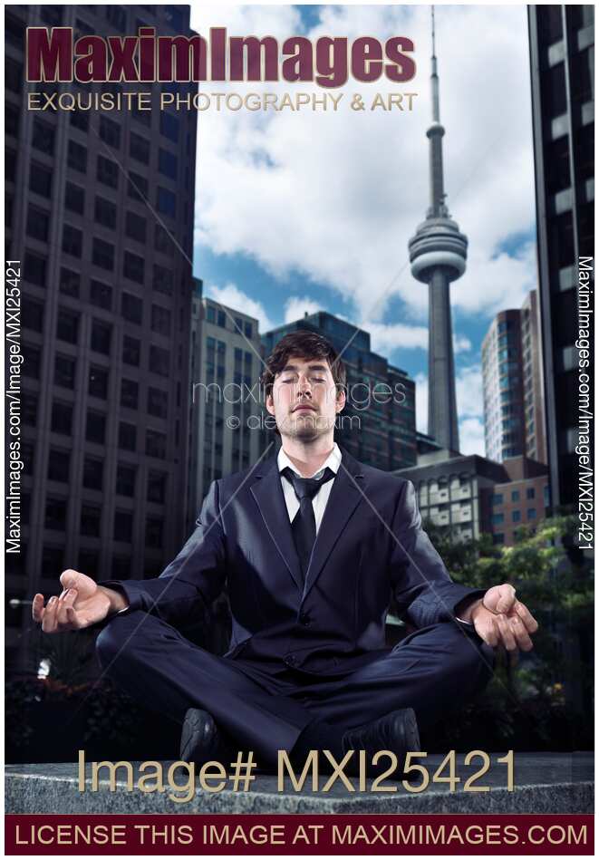 Businessman meditating in downtown Toronto