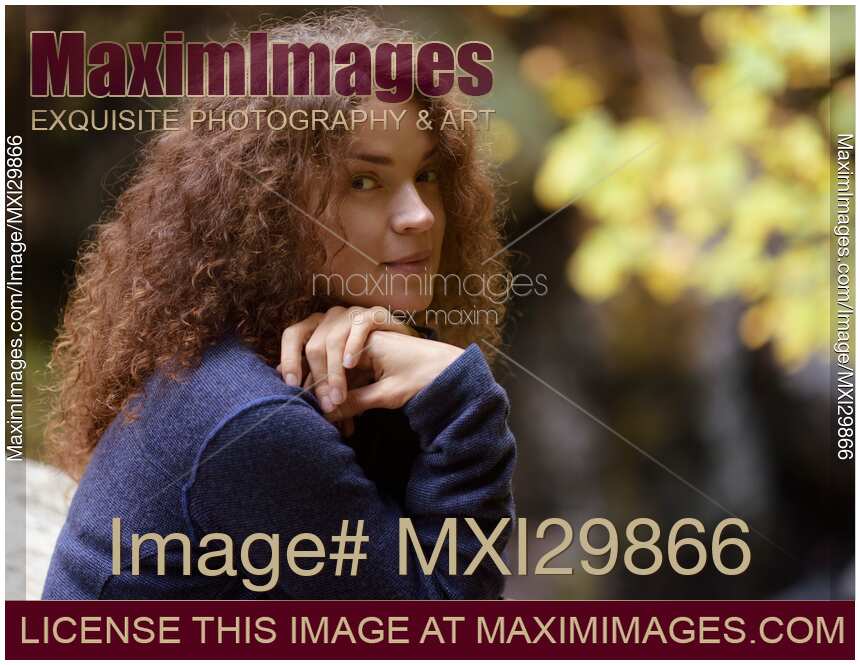 Candid natural portrait of young woman cute smiling expression on her face in the nature
