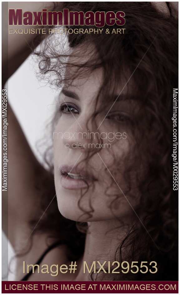 Candid upclose beauty portrait of a young woman face with expressive eyes gazing at the distance