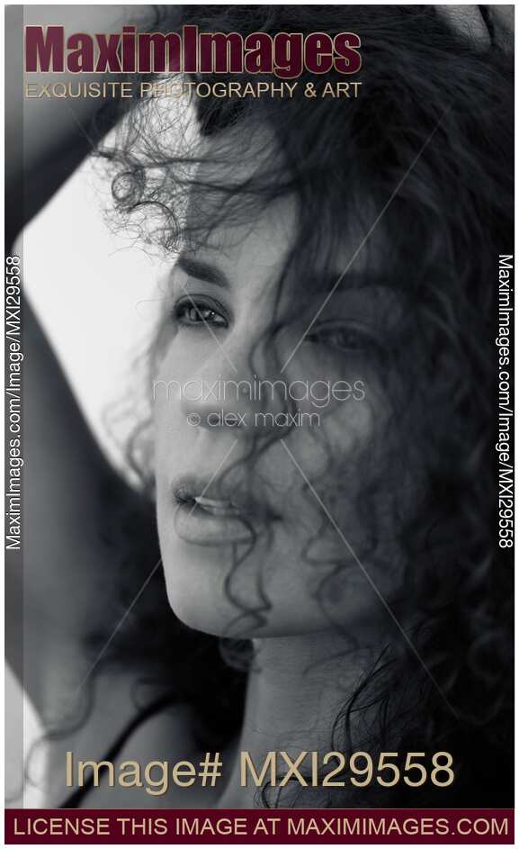 Candid upclose black and white beauty portrait of young woman face with expressive distant eyes