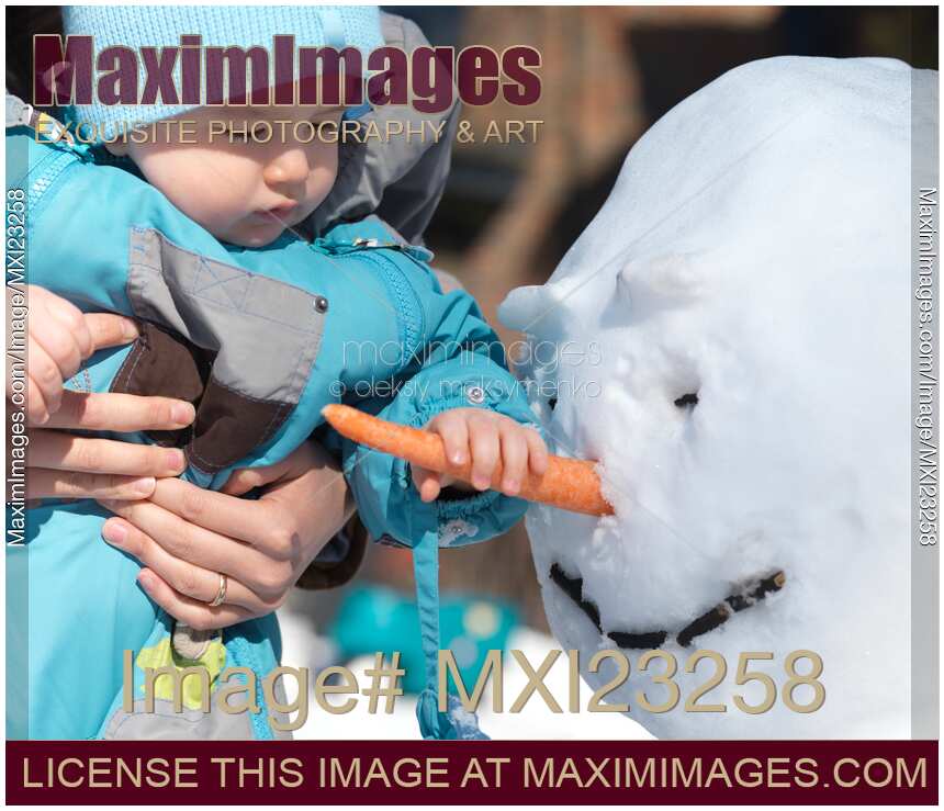 Child Grabbing Snowman's Nose
