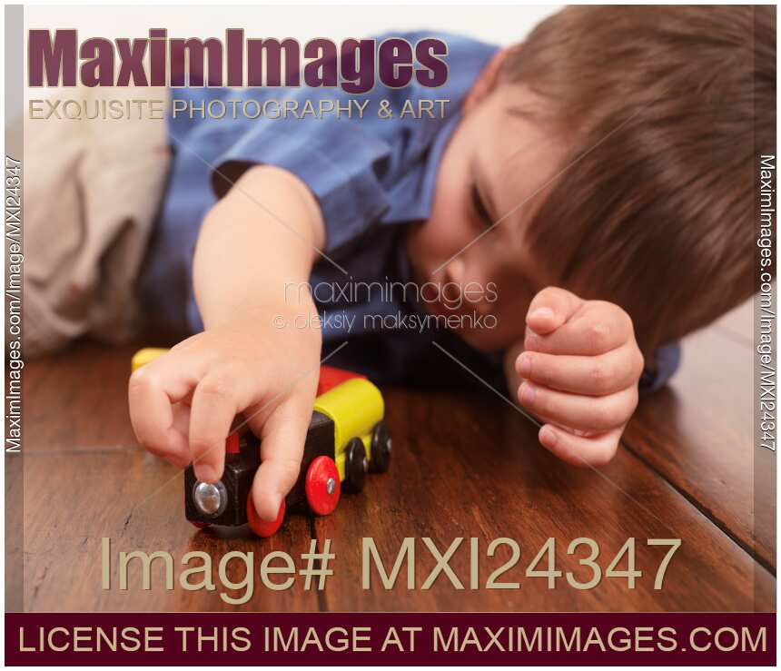 Child playing with a toy train