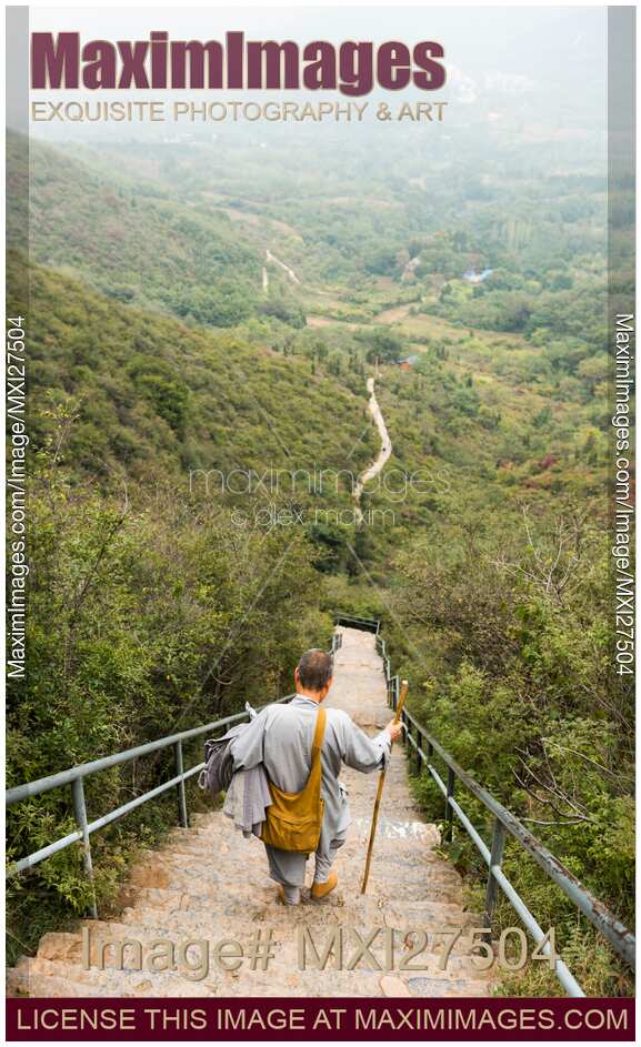 Chinese Buddhist monk walking down the stair at mount Song