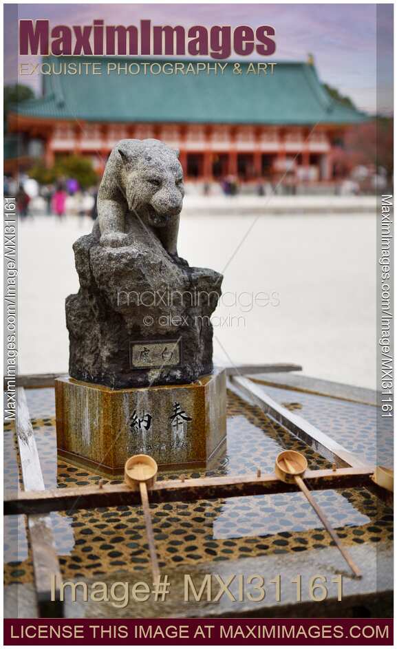 Chozuya water basing with carved stone panther at Heian Shrine