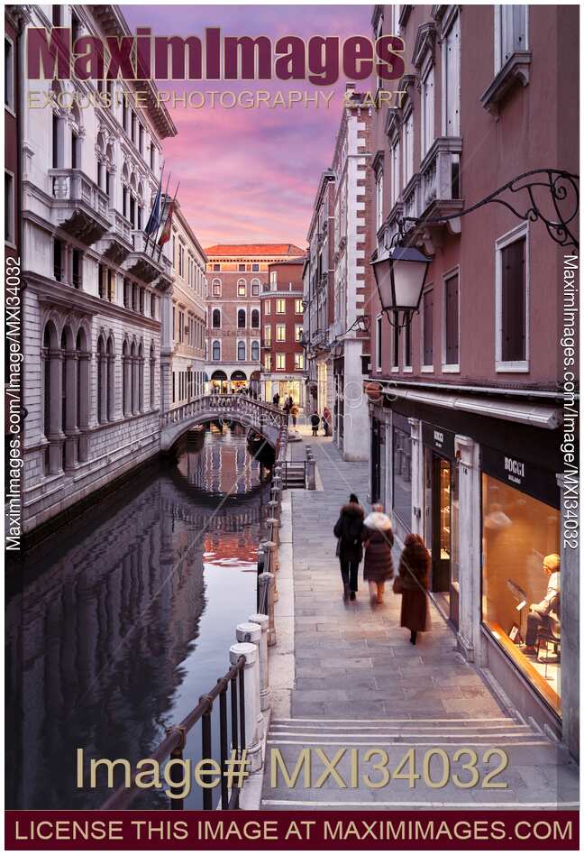 City of Venice sunset street scenery of historic old buildings and a small foot bridge