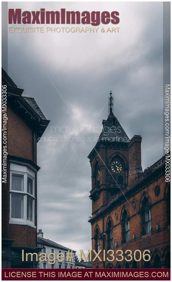 Clock tower in historic dramatic city scenery in Northern Ireland.