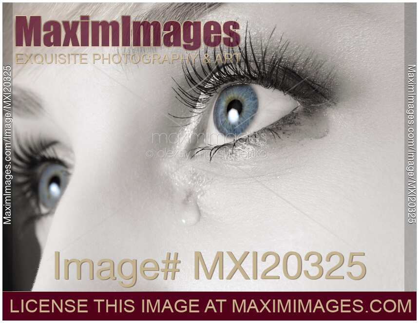 Close-up of tears coming from woman eyes