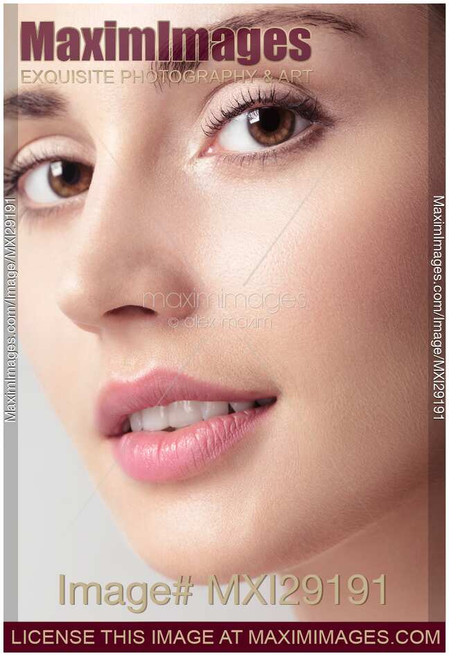 Closeup beauty portrait of young woman face with brown eyes