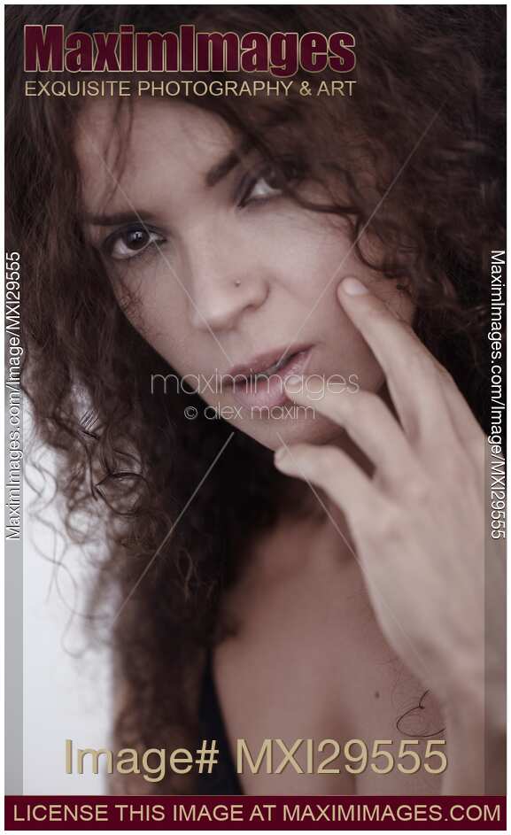 Closeup face portrait of a young brunette woman with a deep expressive look