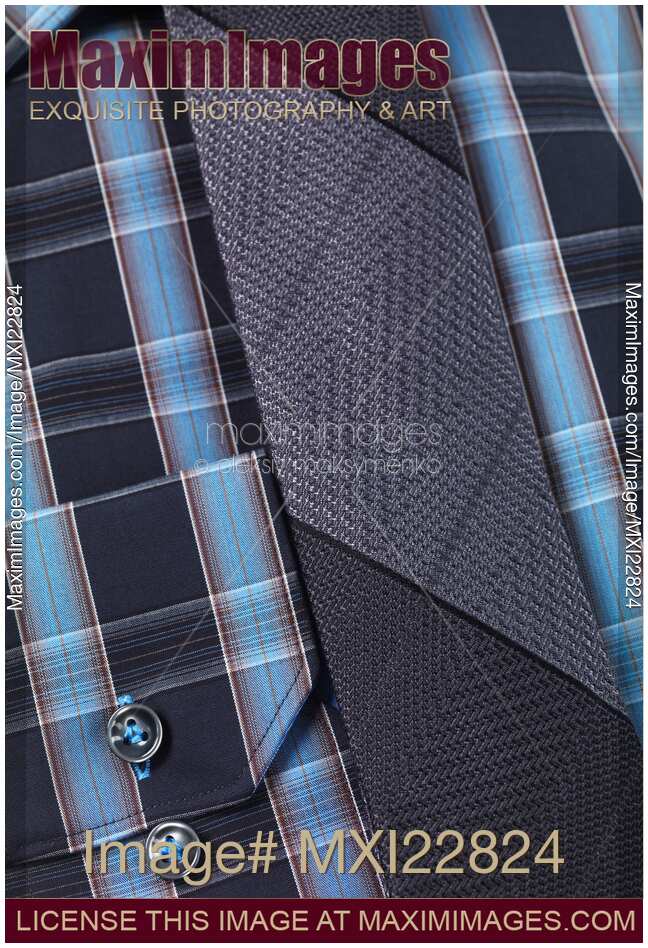 Closeup of a blue tartan shirt with a necktie
