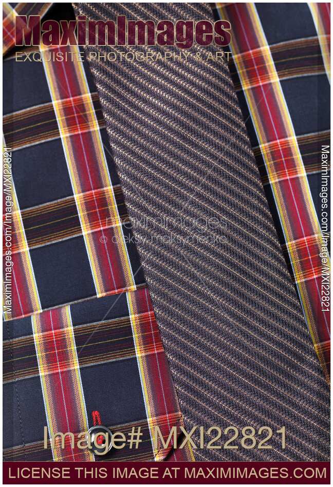 Closeup of a tartan shirt with a tie