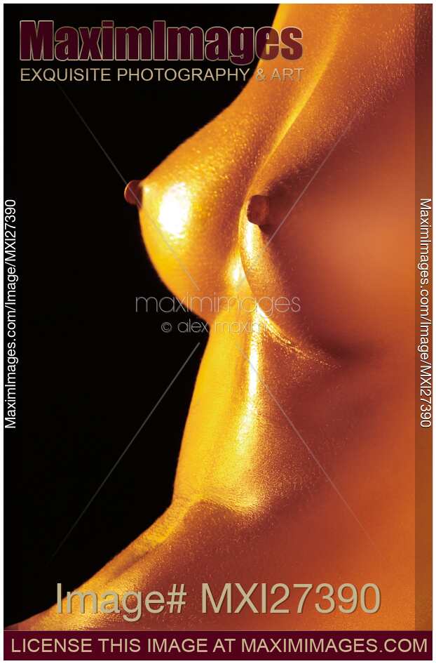 Closeup of bare woman breasts with shiny skin