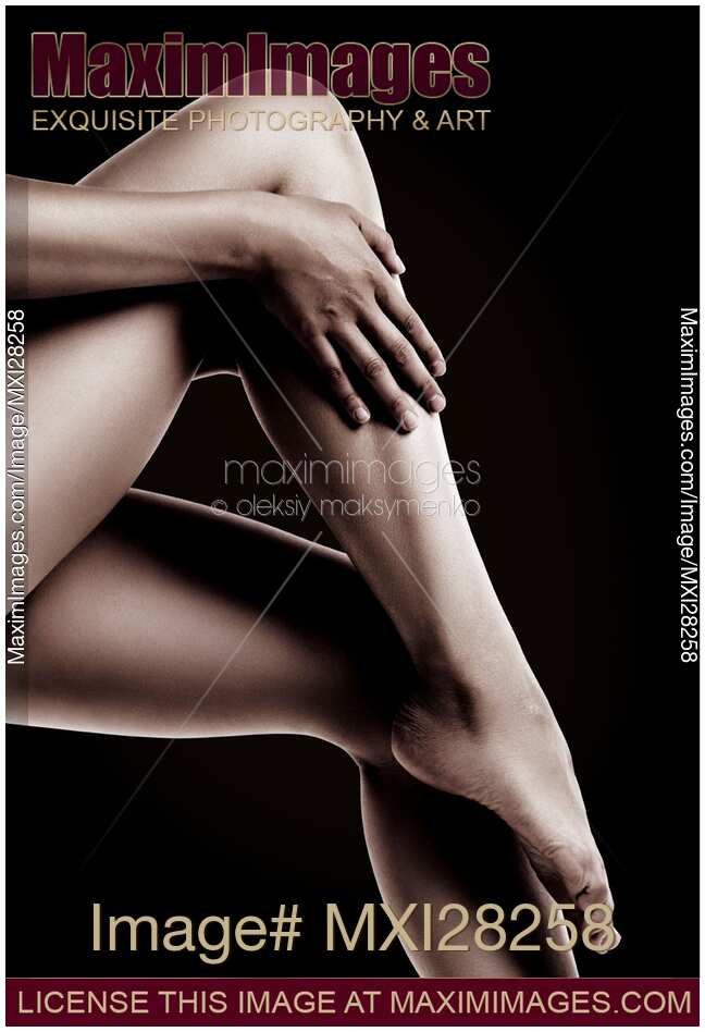 Closeup of Bare Woman Legs on Black Background