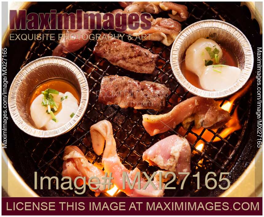 Closeup of beef and scallops grilled on fire