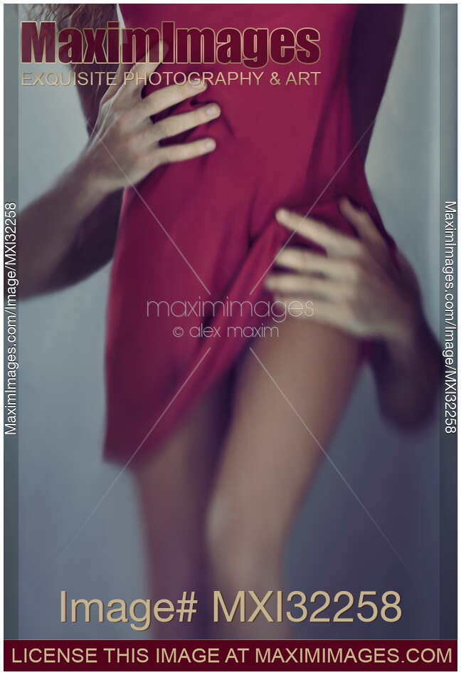 Closeup of male hands touching sexy woman body removing her red dress Abstract body parts