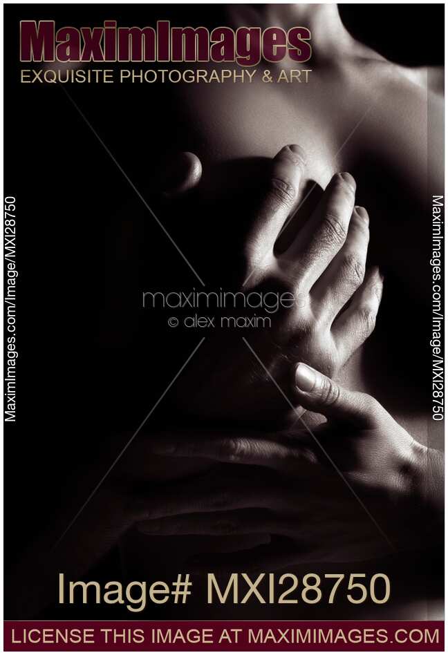 Closeup of man hand on nude woman breast