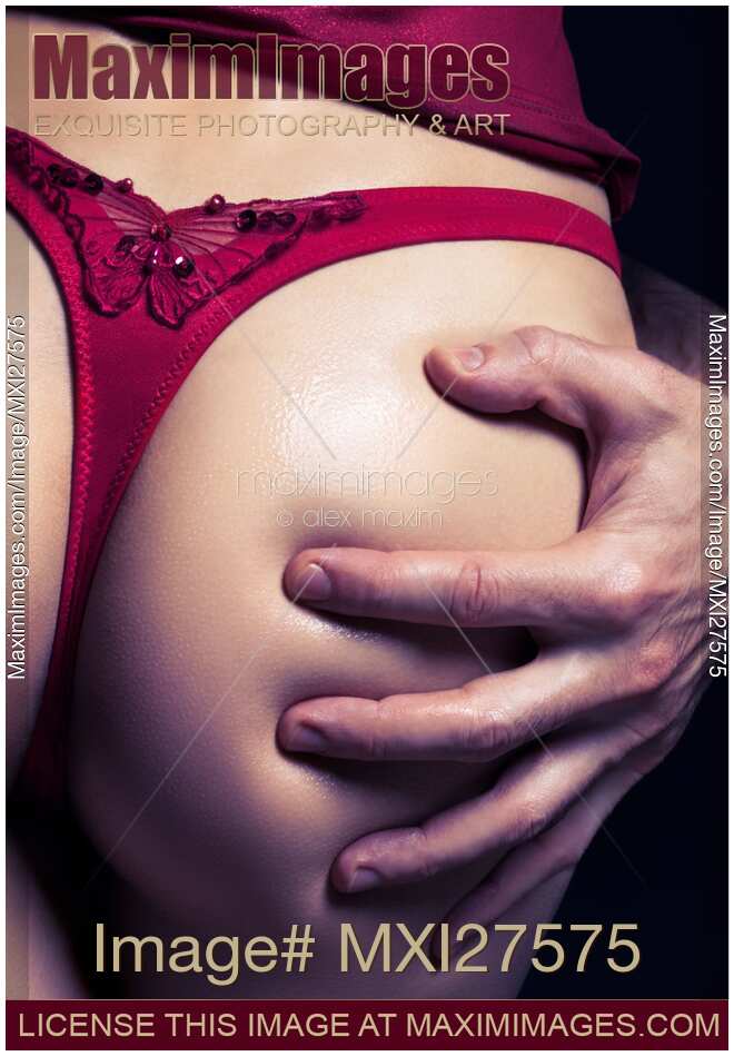 Closeup of man hand on sexy woman buttocks