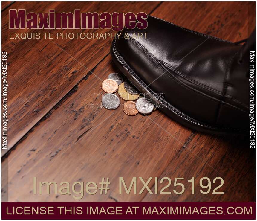 Closeup of man shoe stepping on change
