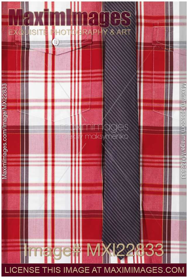 Closeup of red tartan shirt with a skinny necktie
