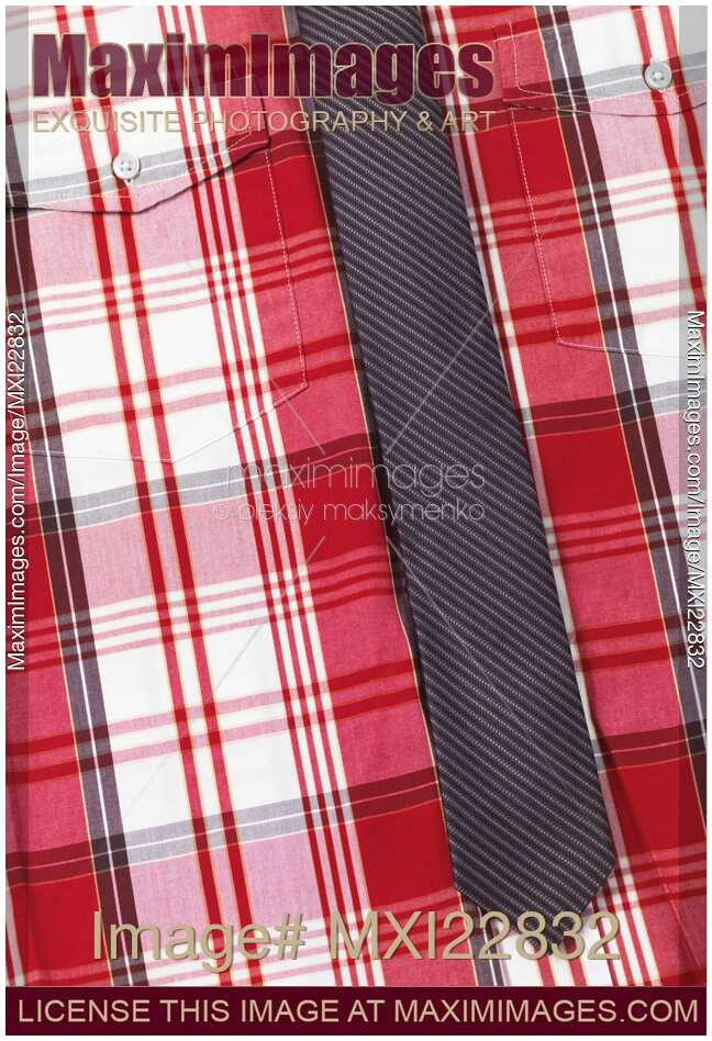 Closeup of red tartan shirt with a slim necktie