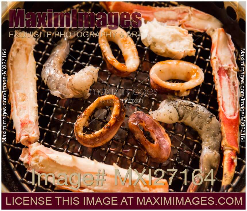 Closeup of seafood on grill stove