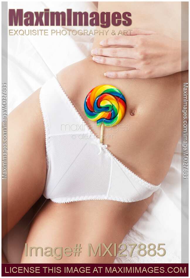 Closeup of sexy woman body with a lollipop in her underwear