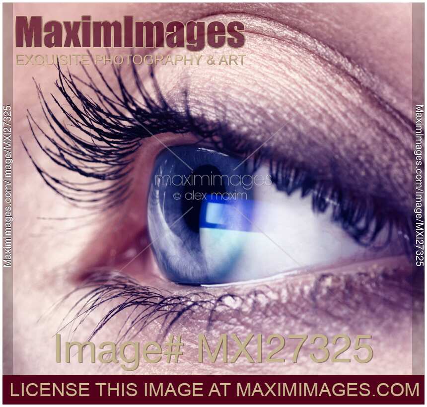 Closeup of woman eye with blue screen reflecting in it