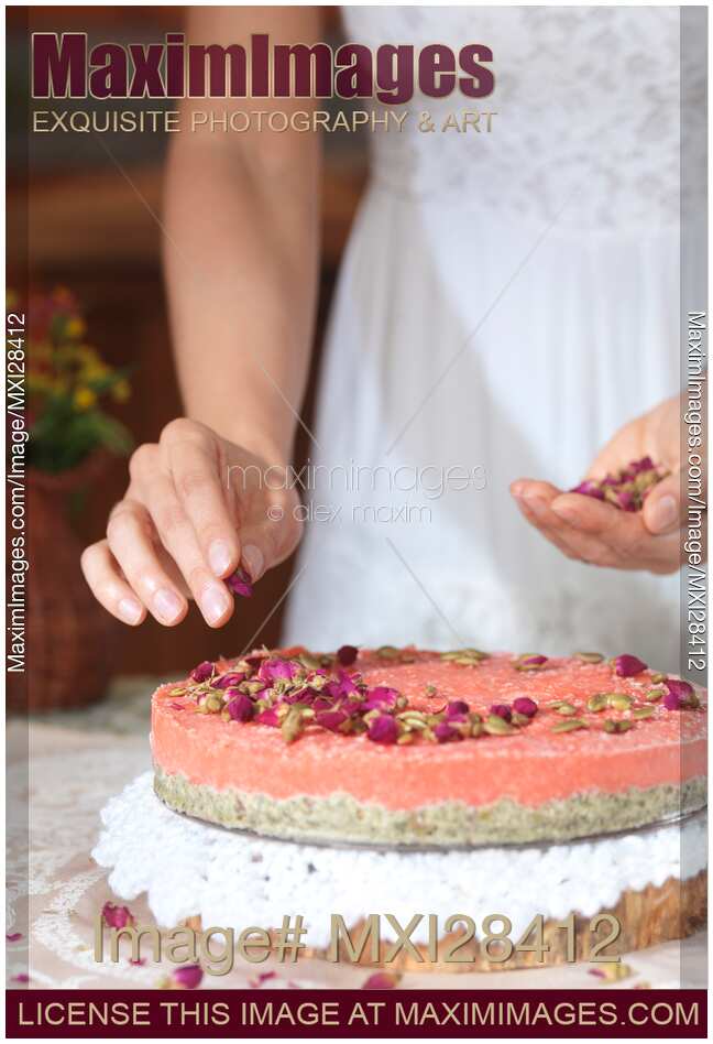 Closeup of woman hands making cake