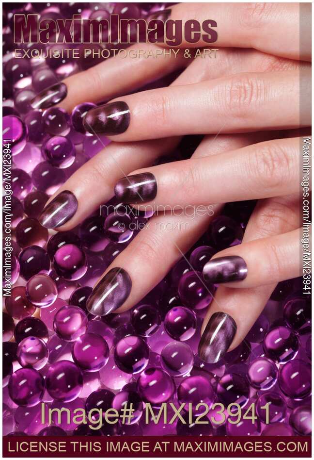 Closeup of Woman Hands With Purple Nail Polish