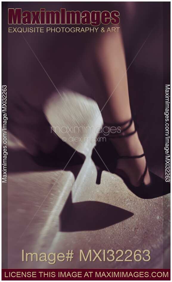 Closeup of woman legs in black high heel shoes walking down the stairs