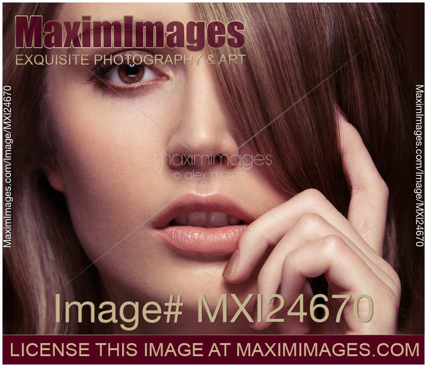 Closeup of young woman face with bangs covering her eye